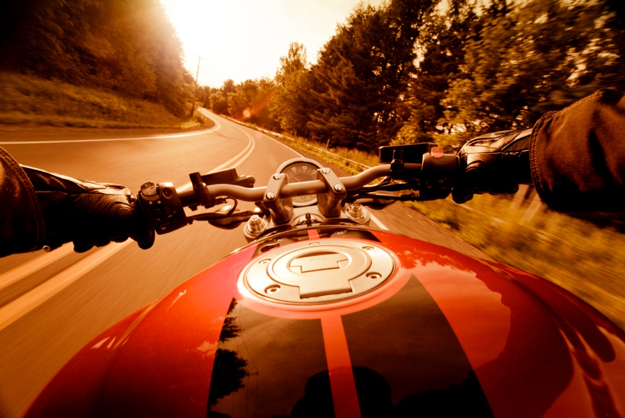 Person Riding Motorcycle on Mountain Road